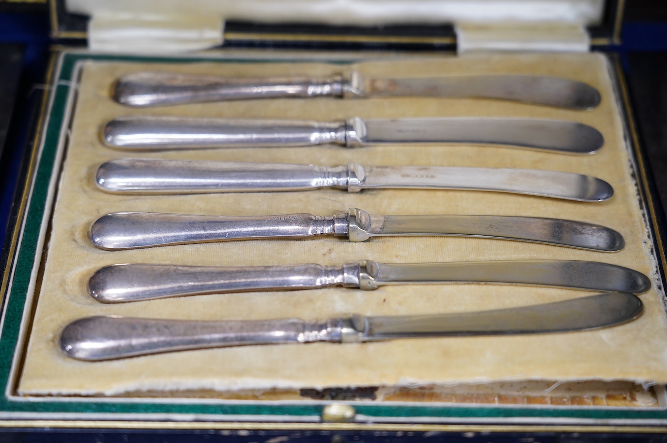 A cased set of six silver handled tea knives and six other cased plated sets. Condition - fair